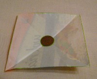 folded square with penny